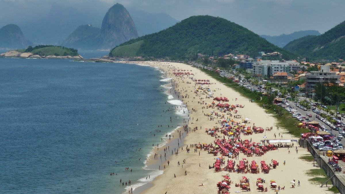 Praia amada em Niterói tem águas calmas e vista para o Cristo Redentor